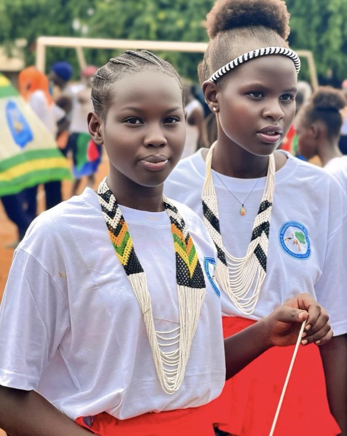 Two young women in traditional beaded necklaces at Peace Cultural Day